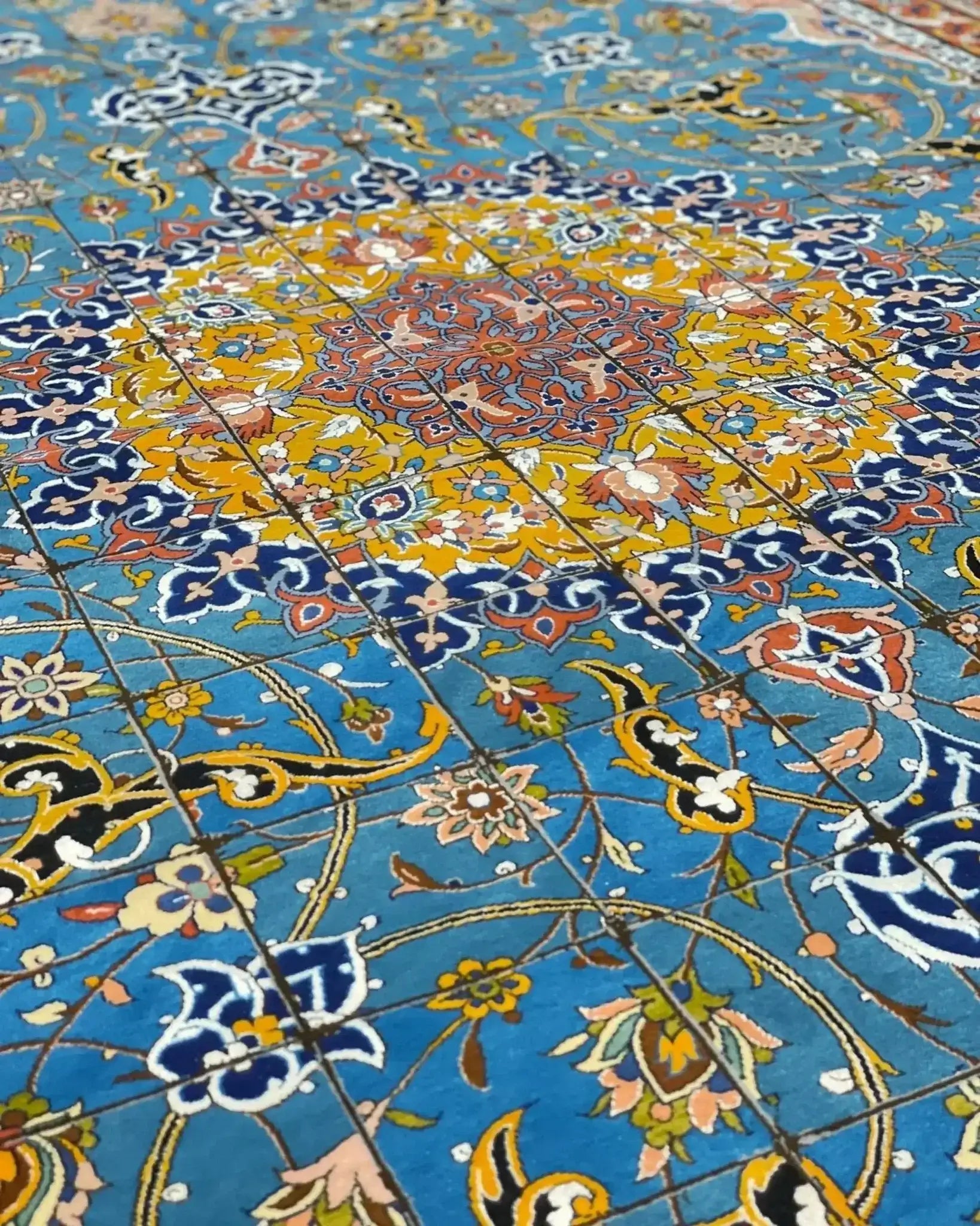 "Master Haghighie’s fine Persian Isfahan rug, featuring rich colors and complex designs, crafted from wool and silk."